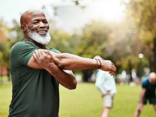 Man Stretching in Field